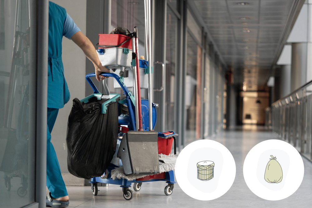 Cleaner walking with her cleaning cart and waste bags in a professional cleaning industry setting.