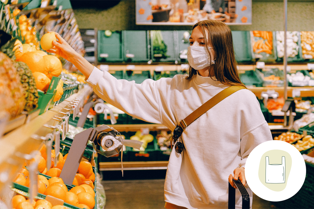 Image of a consumer shopping for fruit in a retail store, with 'vegetable & fruit bags' visible for packaging.